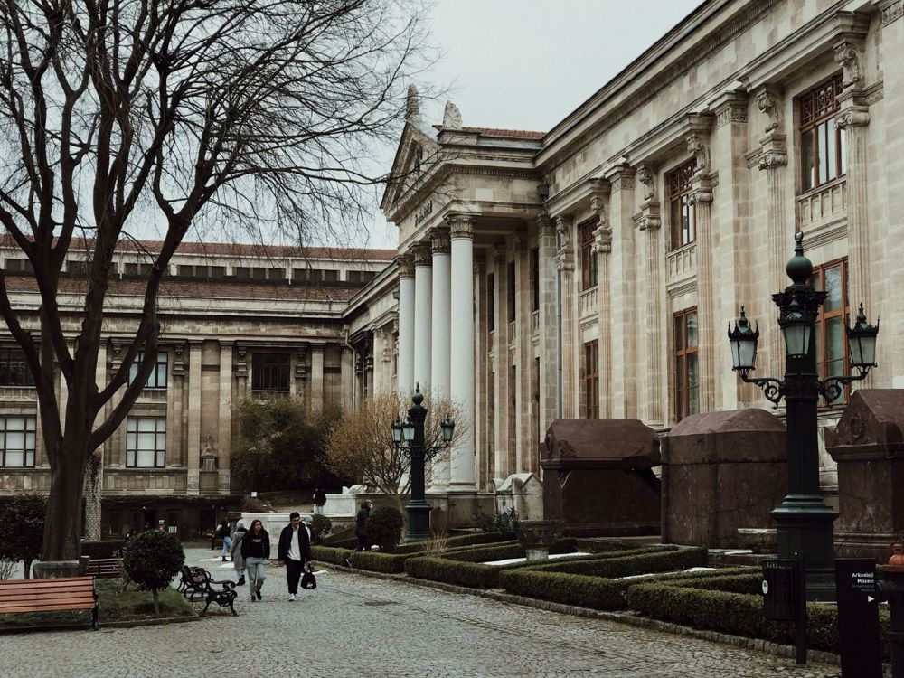 Historic university building with students walking in the courtyard