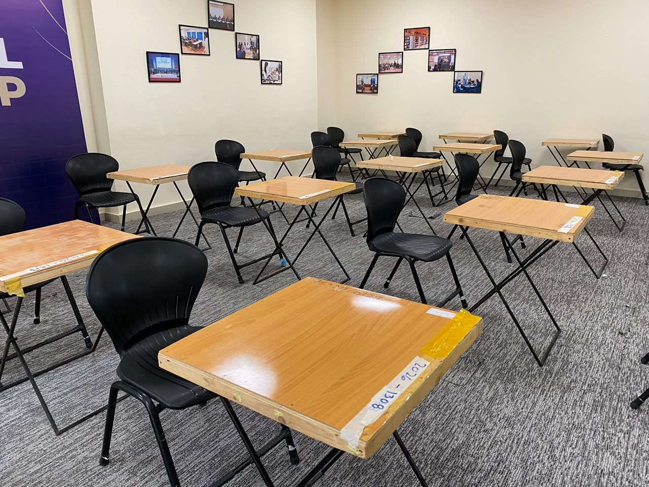 Exam hall with spaced desks and chairs