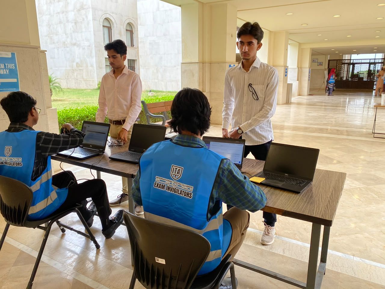 ITA staff verifying candidates on laptops